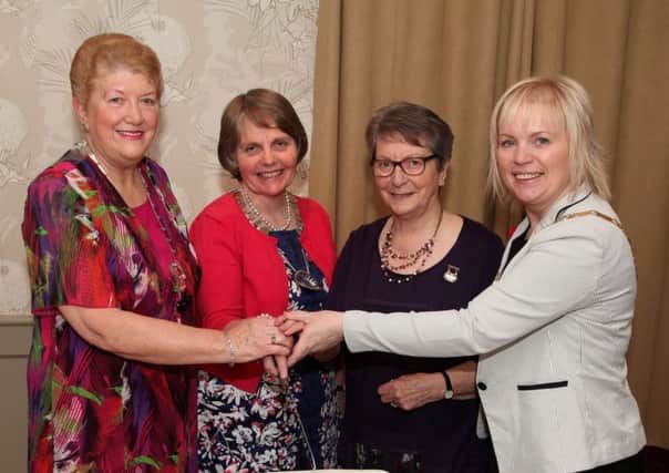 Joyce Jackson (Coleraine WI President), Elizabeth Warden (Federation Chairman), Agnes Kennedy (Executive Member for Lower Bann Area) and Councillor Michelle Knight-McQuillan (Coleraine Mayor) pictured cutting the anniversary cake INCR47-305PL