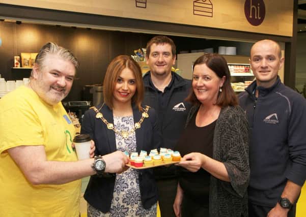 Claire McGowan, proprietor of the new Hi café at the Foyle Arena, offers a special tea-cake to the Mayor Councillor Elisha McCallion, who officially opened the new café and the first customer Barry McDaid.   Included are Foyle Arena staff Jayson McIntyre and Adrian Boyle.  4415-0669MT.