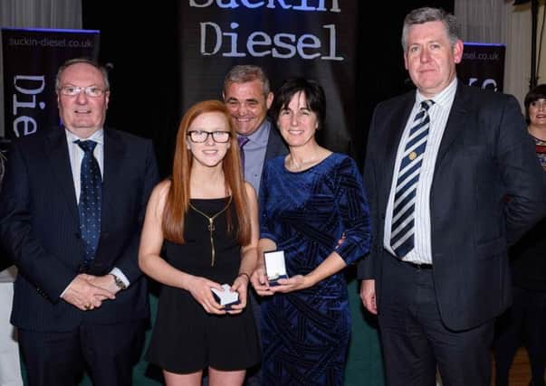 Niamh Callon and Siobhan Poulter receive their special recognition award from Danny McLarnon (Coiste Banaiste Aontroma), Paddy Quinn (Naomh Comhghall Chair), and Colm Walsh (South West Antrim GAA Chair).