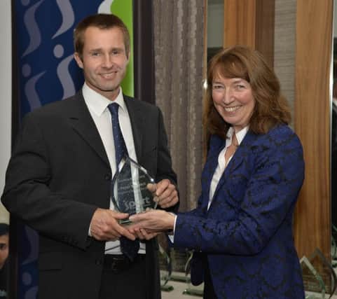 Peter Stewart accepting his award from Cynthia Smith, Deputy Secretary, Dept of Culture Arts & Leisure