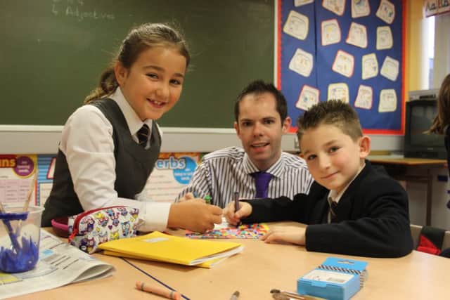 Mr Richard Lawther pictured with P4 pupils working on their November firework project.