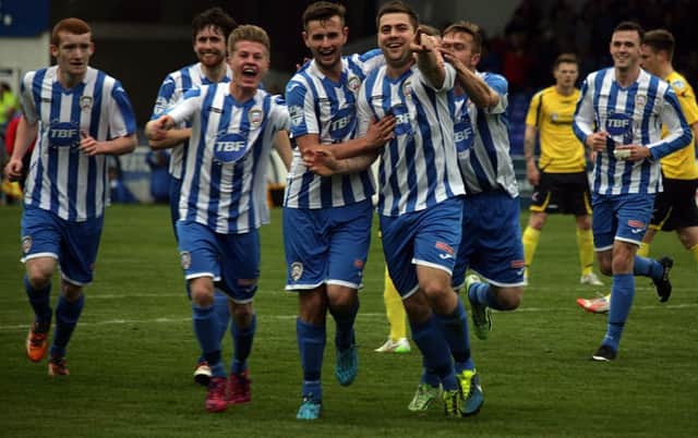 James McLaughlin is mobbed by his Coleraine team-mates as they celebrate his wonder goal against Dungannon Swifts.