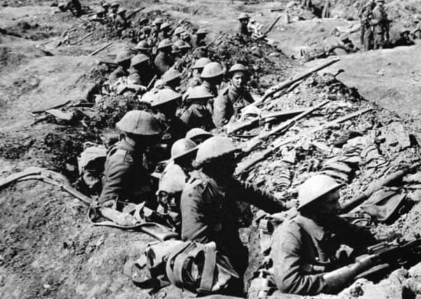 Infantrymen occupying a shallow trench in a ruined landscape before an advance during the Battle of the Somme. (Photo: PA/PA Wire)