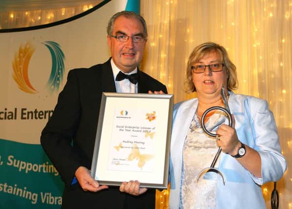 Audrey Murray receives her Social Enterprise Woman of the Year award from Colin Jess, Ulster Banks Head of Not for Profit SME Banking at the Social Enterprise Awards recently.