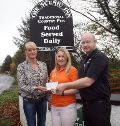 Shirley McKinlay and Steven McFetridge from the Scenic Inn, Armoy, present a cheque for £1500 to Cathryn Gibson, the Northern Ireland fund-raiser for Muscular Dystrophy UK last Wednesday.The money was raised as the result of a two-night charity auction and dance at the Scenic.