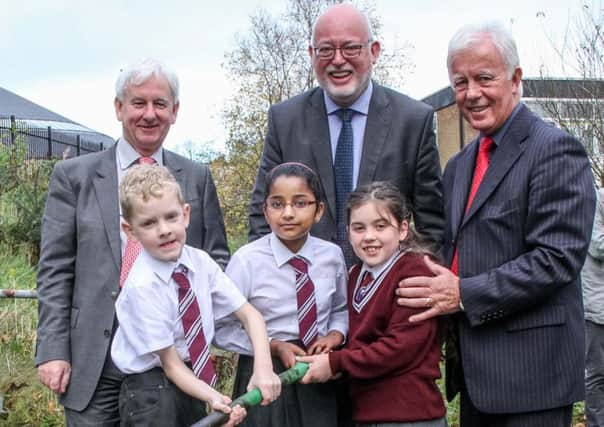 Jim Clarke, chief executive of CCMS, Mr Gavin Boyd, chief executive of the Education Authority, St Bernard's principal Mr Paul Flanagan and pupils Jack Kane, Fiona Phillip and Ellie Gallagher cut the first sod on the school's £1m extension project. INNT 46-501-SO Pic by Shirley O'Neill