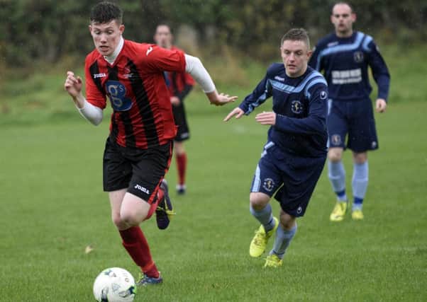 Limavady United/Drummond defender James Payne wins this race for the ball during Saturday's defeat at Tullyally Colts. INLS4615-111KM