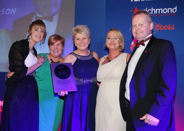 Olga Walls (second from right) presents the team from Front Page Bar, Ballymena with the Commitment to the Community Pub award at Hospitality Ulsterâ¬"s Pub of the Year Awards 2015.  A total of 14 awards were presented at the prestigious ceremony, which was hosted by Cool FM presenter Pete Snodden and held at the La Mon Hotel and Country Club.  The awards are the only industry recognised awards in Northern Ireland.  This yearâ¬"s awards were supported by Britvic, Coca-Cola, Diageo, Dillon Bass, Drinks Inc., Heineken Northern Ireland, Henderson Foods, Molson Coors, Richmond Marketing, Tennentâ¬"s NI, and media partners, Sunday Life, Downtown Radio/Cool FM and Hospitality Review NI. For the full list of winners visit www.nipuboftheyear.org. Photo by Kelvin Boyes, Press Eye.