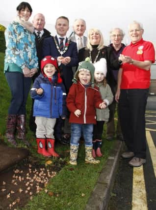 Mayor of Antrim and Newtownabbey, Councillor Thomas Hogg along with Helen Canning, Max, Cooper and Lucy of Jolly Tots Childcare in Antrim, help to plant crocus bulbs at Antrim Forum as part of the Rotary Club's Focus on the Crocus campaign. They are joined by Jeoff Irons, Robert Elliott, Denis Boyd and Heather Montgomery (President) of Antrim Rotary Club and Martin Sayliss of Newtownabbey Rotary Club.