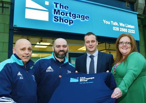 The Mortgage Shop, Church Street, Ballymena; staff members Ryan O'Neill and Judy Conway present new T-shirts to Seven Towers FC members Ally Gordon and Seamus McDonald. INBT 46-805H