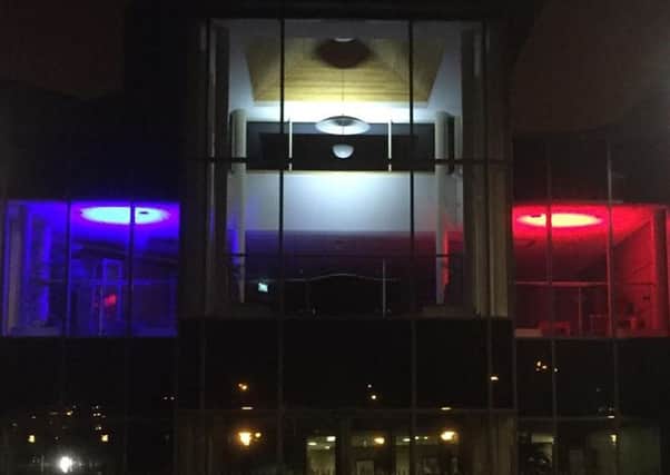 Craigavon Civic Centre lit up in the colours fo the French flag.