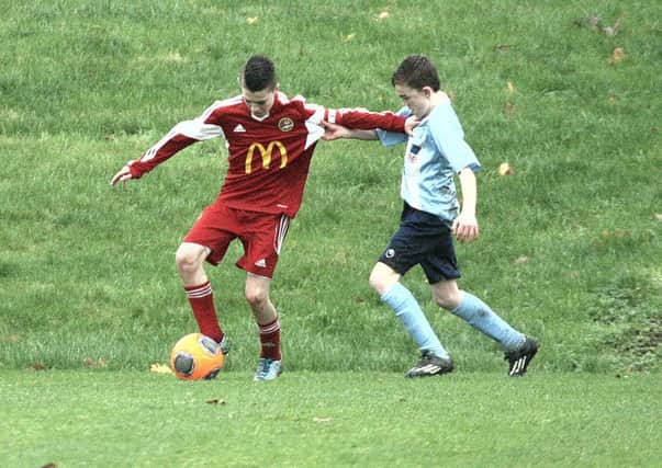 Carniny Youth under-14s and their Ballymena United counterparts tussle for possession during Saturday's NIBFA Cup tie.