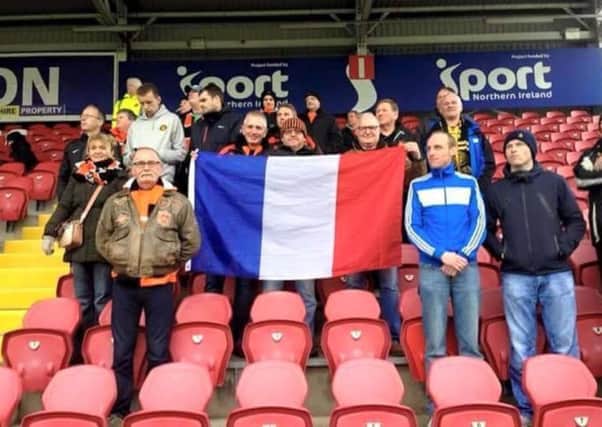 Carrick Rangers fans, pictured at Shamrock Park, show their solidarity with the France following Friday's terrorist attacks in Paris.  INLT 47-909-CON
