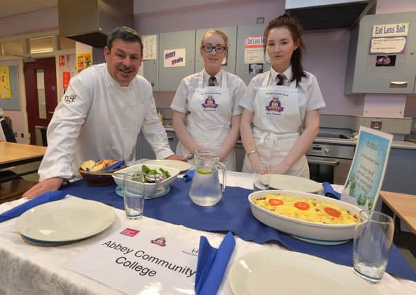 Abbey Community College pupils Taylor Redpath and Jamie Baker pictured with one of the judges at the final of the Kitchen Whizz Kids cookery competition. INNT 47-806CON