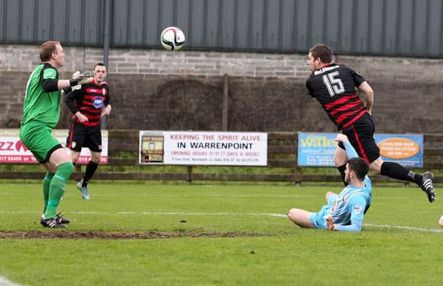 James McLaughlin scores the opening goal past  Warrenpoint Town goal keeper  Aaron Shananan during Saturday's Danske Bank Premiership match at Milltown. 
Picture by Brian Little/Presseye