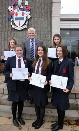 The principal of the Ballymena Academy Mr Black joins his students who received Women's Aid 'It's a Teen Thing' awards last week at the school. INBT 47-803H