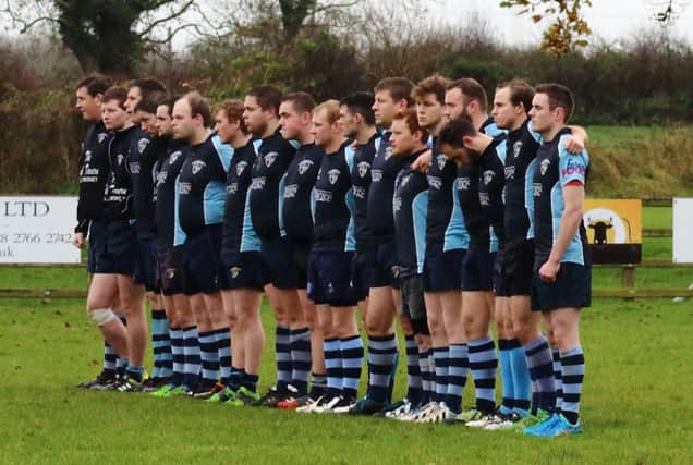 Ballymoney Second XV pictured on Saturday observing a minute's silence to pay tribute to those who died in Paris  prior to their match against Cooke.