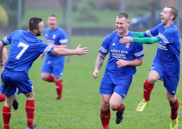 Sandy Row players celebrate a goal against Glaston, at Brooke Activity Centre. US1546-509cd  Picture: Cliff Donaldson
