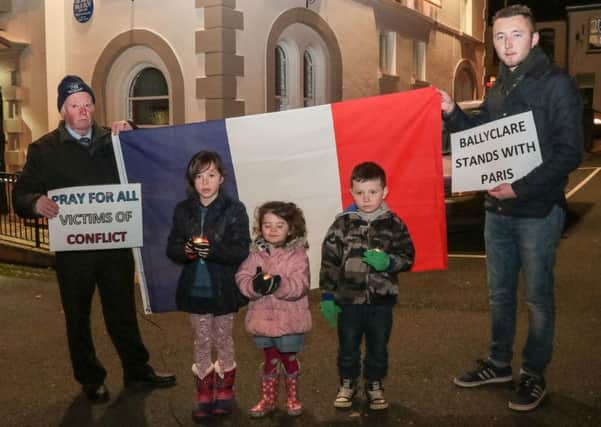 Paddy Kelly (left) and Jordan Greer (right) with Miya, Faye and Alex McCalmont at the 'Prayers for Paris' vigil in Ballyclare. INNT 47-504-SO