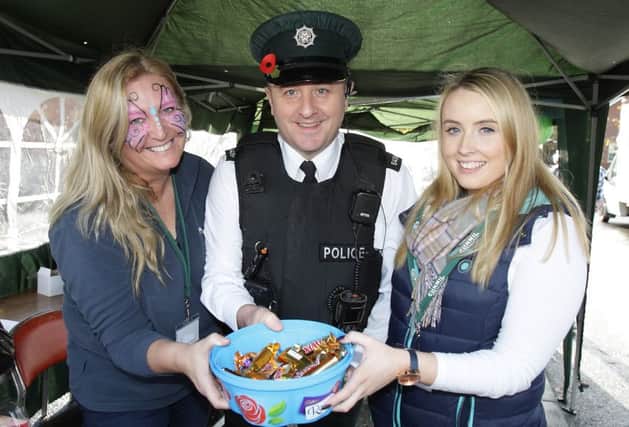 Angela Roachy and Michaela McCusker with community policing officer Constable White at the family fun day at Causeway Meadows. US1545-512cd  Picture: Cliff Donaldson