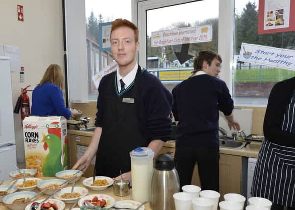 One of the pupils at Beechlawn School shows off the breakfast the school provides