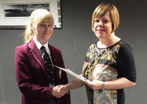 Kelli Bagchus, Carrickfergus Enterprise and chair of the judging panel, presents Emma Cooper of Carrickfergus Grammar with her certificate. INCT 46-796-CON