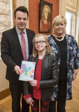 Molly Bradley pictured with Colum Eastwood MLA and her mum at the launch of My Journey, My Voice multimedia portraits and stories exhibition to raise awareness of communication disability at Parliament Buildings, Stormont.