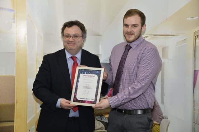 Iain Weir receiving his Deloitte Human Capital Academy certificate from Employment and Learning Minister Dr Stephen Farry. INCT 47-705-CON