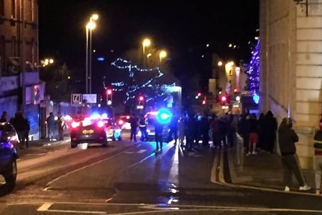 Police move in to separate rival factions at Bridge Street during disorder following the Ballymena United v Coleraine match.