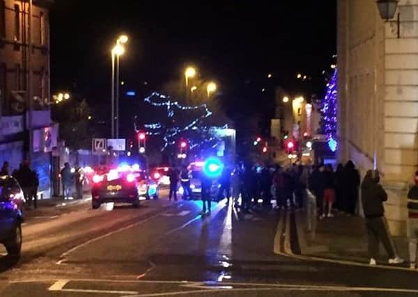 Police move in to separate rival factions at Bridge Street during disorder following the Ballymena United v Coleraine match.
