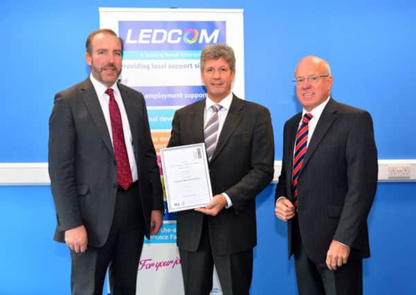 The chairman of Invest NI, Mark Ennis (centre) presents the Customer Service Excellence Standard certificate to LEDCOM chief executive, Ken Nelson (left) and Chairman Henry Fletcher (right). It is the first Northern Ireland enterprise centre to be granted the coveted award.  INLT 48-650-CON