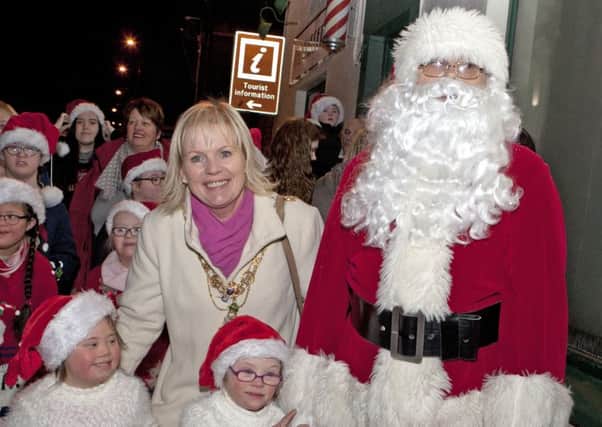 STREET CRED. Mayor Cllr Michelle Knight-McQuillan and Santa with children from the Causeway Down Syndrome Group made their way to the stage on Thurs night.INBM48-15 022SC.