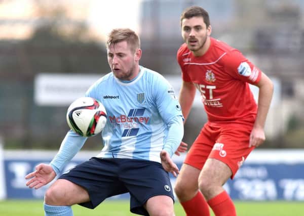 Ballymena United's David Cushley shields the ball from Portadown defender Chris Ramsey during today's Danske Bank Premiership game at the Showgrounds. Picture: Press Eye.