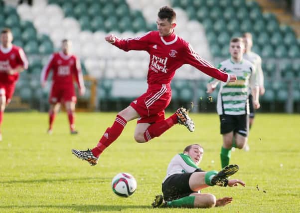 Ballyclare's Michael O'Hanlon skips this challenge from Donegal Celtic's Ryan Dunlop. INLT 48-902-CON Picture: Jonathan Porter/PressEye