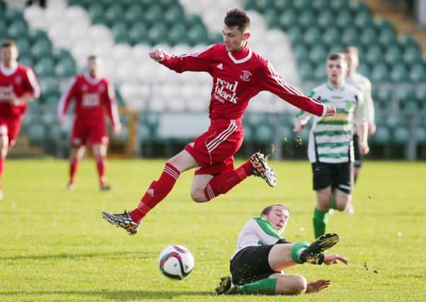 Ballyclare's Michael O'Hanlon skips this challenge from Donegal Celtic's Ryan Dunlop. INLT 48-902-CON  Picture: Jonathan Porter/PressEye