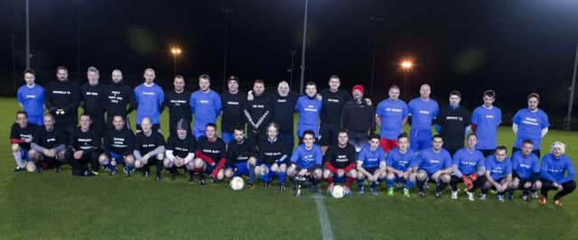 NEVER FORGOTTEN. Past and present players from Riada FC along with organiser Mervyn 'Tubes' McIntyre and ref at the Chrissy Hendrie Memorial Football Match on Friday night.INBM48-15 035SC.