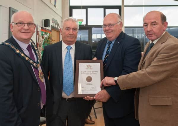 Cllr Billy Ashe joins Derek McKay and Wallace Elder from Ahoghill in Bloom as they are congratulated on their Communities in Bloom win by the Canadian Consul, Ken Brundle, second from right. (Submitted Picture)