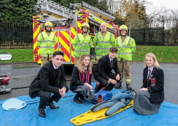 Pupils Chris Taggart, Beth Gault, Owen Kirk and Kirsty McBarnet with NIFRS personnel at the road traffic collision demonstration. INNT 47-505-SO