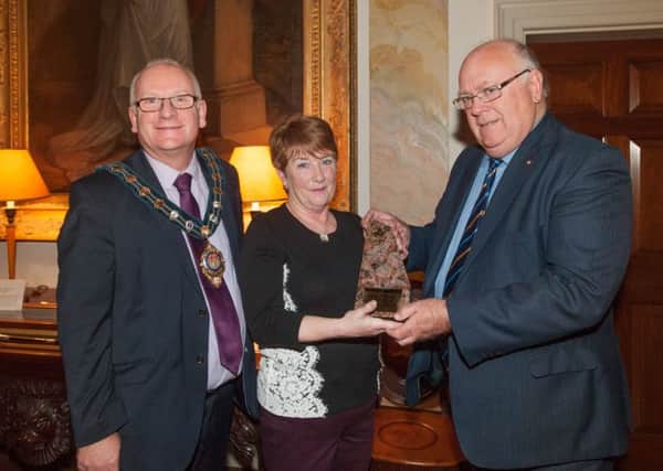 Glenarm volunteer Rosaleen Maybin and Mayor of Mid and East Antrim, Councillor Billy Ashe accept the Award from Honorary Canadian Consul, Ken Brundle.  INLT 48-651-CON