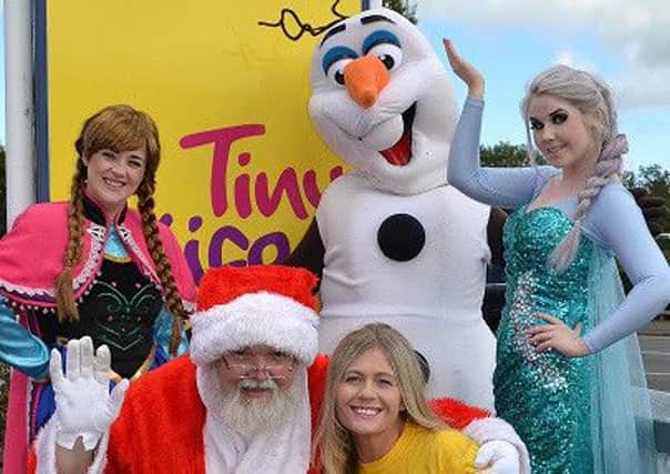 The princesses from Frozen and Santa with a Tiny Life representative.