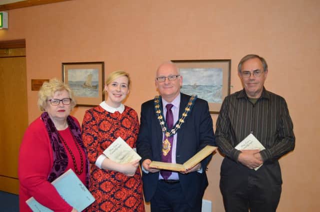 Helen Rankin (left), chair of Carrickfergus and District Historical Society, officially hands over Mrs Coes original manuscript to the Mayor of Mid and East Antrim Borough Council, Councillor Billy Ashe, included are Shirin Murphy, Museums officer and Ron Bishop, editor. The manuscript will now be permanently housed in Carrickfergus Museum. INCT 47-756-CON