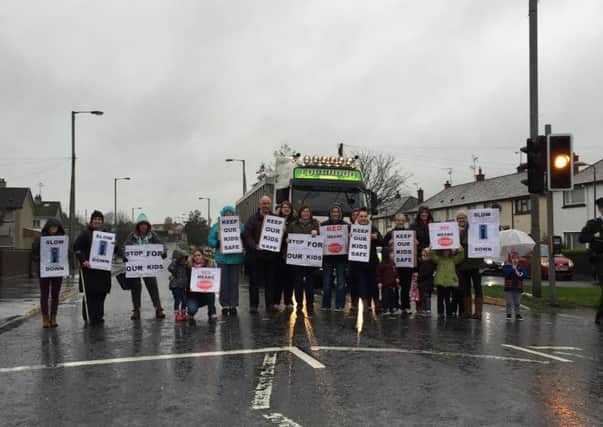 Protesters on the pedestrian crossing on Morgans Hill Road where a number of children have had near misses