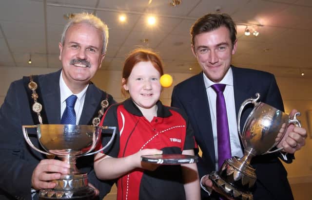 Mayor Thomas Beckett, table-tennis player Sophie Earley and Gareth Gibson, from Douglas Huston Estate Agents, sponsors, at the launch of the Ulster Open Table Tennis Championships, which take place at Lisburn Racquets Club on November 27 and 28. US1545-536cd  Picture: Cliff Donaldson