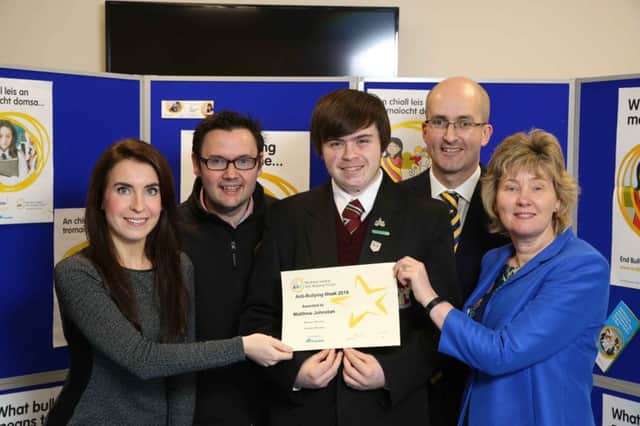 Matthew Johnston, Ulidia Integrated College, is congratulated on his creative writing by Ursula Henderson, Translink; Lee Kane, Regional Anti-Bullying co-ordinator NIABF; Dr Noel Purdy, chair of NIABF and Katrina Godfrey, deputy secretary Department of Education. INCT 47-792-CON
