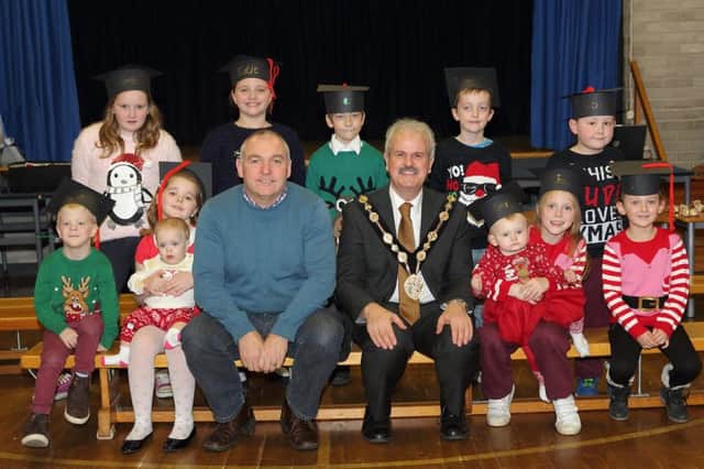 Adrian Bird, from Resurgam Trust, and Mayor Thomas Beckett pictured with children from Hub 2 at Largymore Primary School who graduated from Save The Children's FAST project. US1548-502cd  Picture: Cliff Donaldson