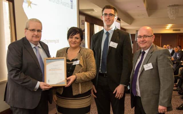 David Quin (left), Supply Chain director, B/E Aerospace (UK) Ltd, presents the bronze award to Joanne Liddle, director, Hugh Henry, engineer, and John McPherson, Operations manager, from IPC Mouldings, Carrickfergus. INCT 48-706-CON