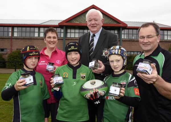 Elene Michaelides, from Visit Derry, Moss Dineen, centre, and Scott Pollock, Mini Rugby coordinator at City of Derry RFC, pictured with some of the young rugby players, from left, Jack Craig, Meabh Clenaghan and Rhys Gillen who helped to launch jars of Rugby Ruck sweets from the Visit Derry/Legenderry Licks range at Judges Road on Saturday morning. INLS4115-136KM