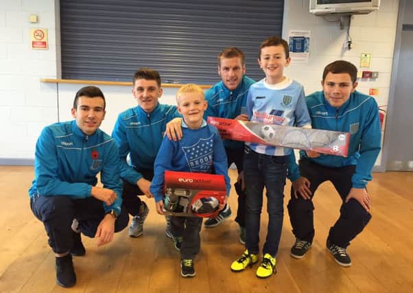 Jamie Black and Craig McQuillan who were winners of the Junior Sky Blues' November prize draws pictured with players Matthew Ferguson, Paddy McNally, Darren Henderson and Eoin Kane.