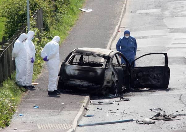 Forensics at the scene of a booby-trap car bomb attack on an off-duty  Catholic policeman on the Drumnaby Road outside Castlederg in Co Tyrone. 
Pic Colm Lenaghan/Pacemaker 13/5/08