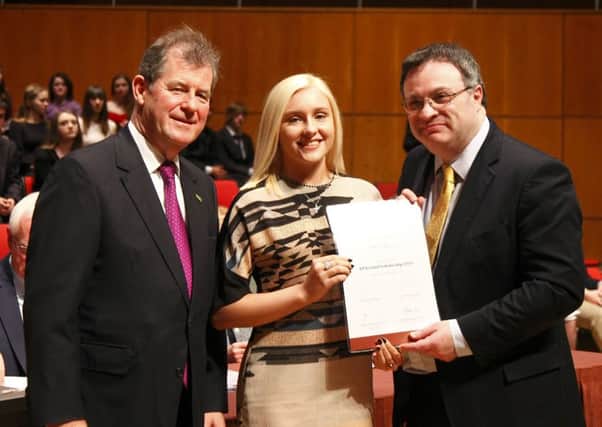 Chloe Morrison receiving her certificate from JP McManus and Employment and Learning Minister Dr Stephen Farry.